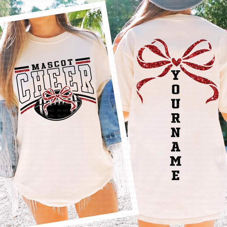 May include: White t-shirt with "MASCOT CHEER" text and a football graphic with a red bow. The back of the shirt features a large red glitter bow and the word "YOUR NAME" vertically.