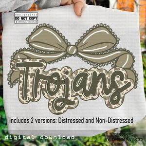 May include: A digital download featuring the word "Trojans" in a camouflage pattern with a decorative bow. The design includes two versions: distressed and non-distressed. The text "designwinco DO NOT COPY ORIGINAL DESIGN" is also visible.