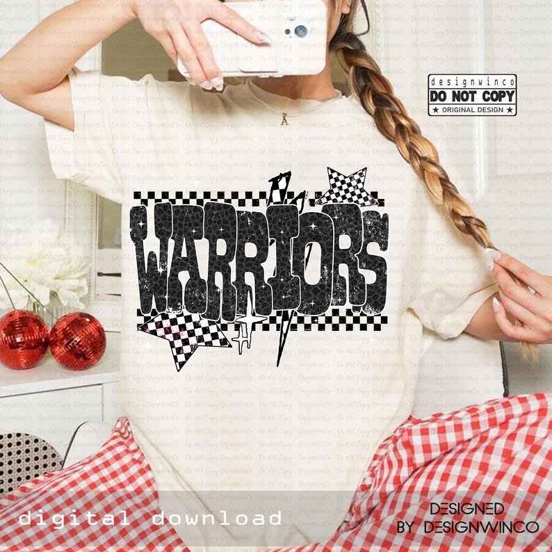 May include: Cream-colored t-shirt with the word "WARRIORS" in a black, textured font. The design includes checkered patterns, stars, and lightning bolts. The text "DIGITAL DOWNLOAD" and "DESIGNED BY DESIGNWINCO" are also visible.