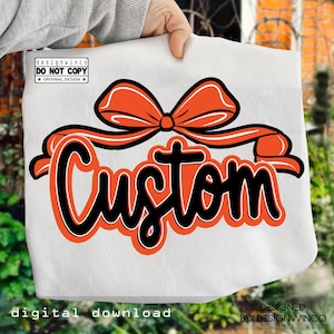 May include: White tote bag with an orange bow and the word "Custom" in black and orange lettering. The bag also includes the text "digital download" and "designed by designwinco".