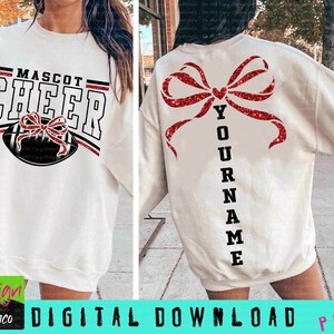 May include: White sweatshirt with "MASCOT CHEER" text and a football graphic on the front. The back features a large red glitter bow and the word "YOUR NAME" in black. The design is a digital download.