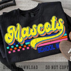 May include: Black sweatshirt with the word "Mascots" in yellow, outlined in blue and red, with a retro font. Below the word are horizontal stripes in blue, orange, and pink. The text "SCHOOL N" is below the stripes. The sweatshirt is a digital download.