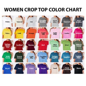 May include: A color chart for women's crop tops, showcasing a variety of colors. The chart includes shades like white, natural, ash, graphite heather, sport grey, charcoal, and dark heather. Other colors include daisy, gold, orange, coral silk, light pink, azalea, and heliconia.