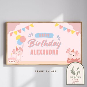 May include: Pink and blue birthday banner with the text "Happy Birthday ALEXANDRA" and two cartoon axolotls. The banner has a festive design with flags and balloons.