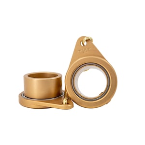 May include: Two gold-colored metal pulleys with a small loop on the top of one. The pulley on the right has the text "Made in the USA" on the side.