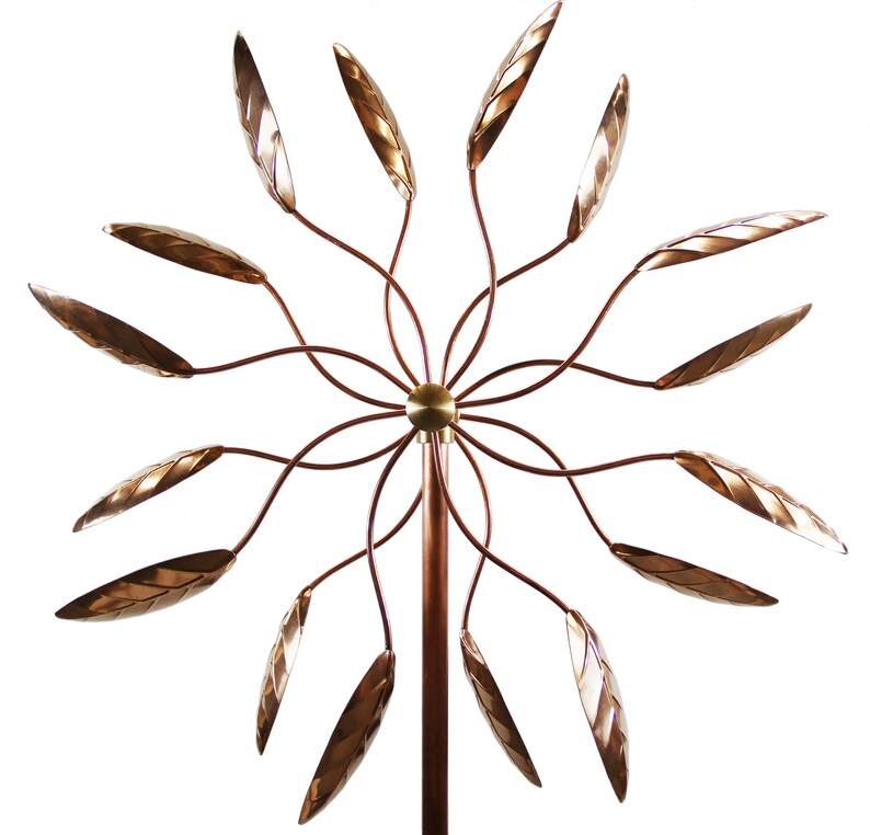 May include: A copper wind spinner with 12 leaves that spin in the wind. The leaves are shaped like elongated teardrops and have a textured surface. The wind spinner is mounted on a copper pole.
