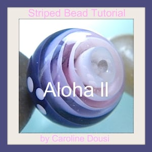May include: Close-up of a purple, pink, and white striped glass bead with white dots. The bead has a swirl pattern and the text "Aloha II" is written on it.