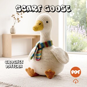 May include: A crochet goose stuffed animal with a white body, yellow beak, and orange feet. The goose wears a small, multi-coloured striped scarf. The text SCARF GOOSE and CROCHET PATTERN appear in the image, along with a circular PDF icon.