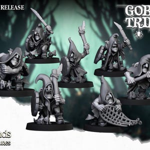 May include: A set of seven grey plastic goblin miniatures, each with a different weapon or tool, standing on a black base. The miniatures are part of the Goblin Tribes collection by Highlands Miniatures.