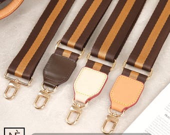 May include: Four brown and tan striped straps with gold metal clasps. Each strap has a different colored leather patch attached to the end.
