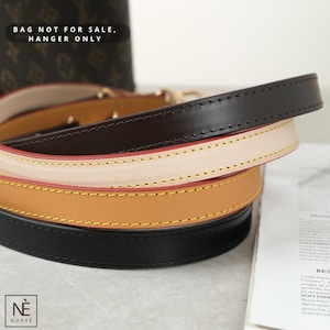 May include: Close-up of four leather bag straps in black, brown, tan, and cream. The straps are stacked, showing the different colours and stitching details. The text "BAG NOT FOR SALE, HANGER ONLY" is visible in the background.