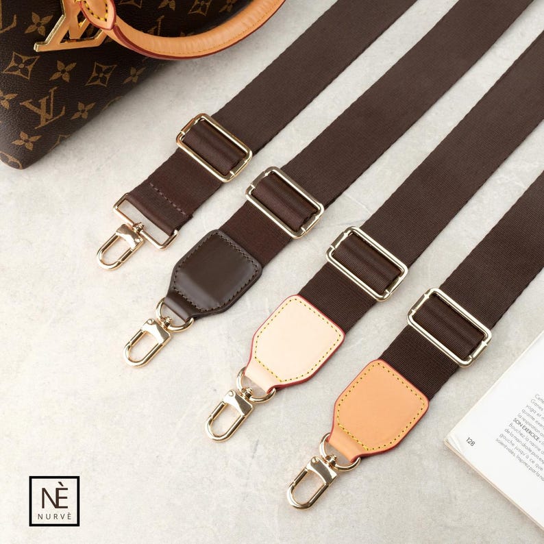 May include: Four brown purse straps with gold-coloured metal hardware. The straps have a dark brown fabric with gold-coloured metal buckles and clasps. Some straps have leather shoulder pads in various colours, including brown and tan. The straps are angled diagonally.