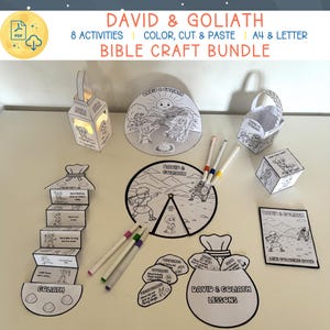 May include: A collection of black and white Bible craft activities, including a lantern, basket, cube, and booklet, with the text "DAVID & GOLIATH" and "BIBLE CRAFT BUNDLE". Also includes coloring pages, markers, and cut-and-paste elements.