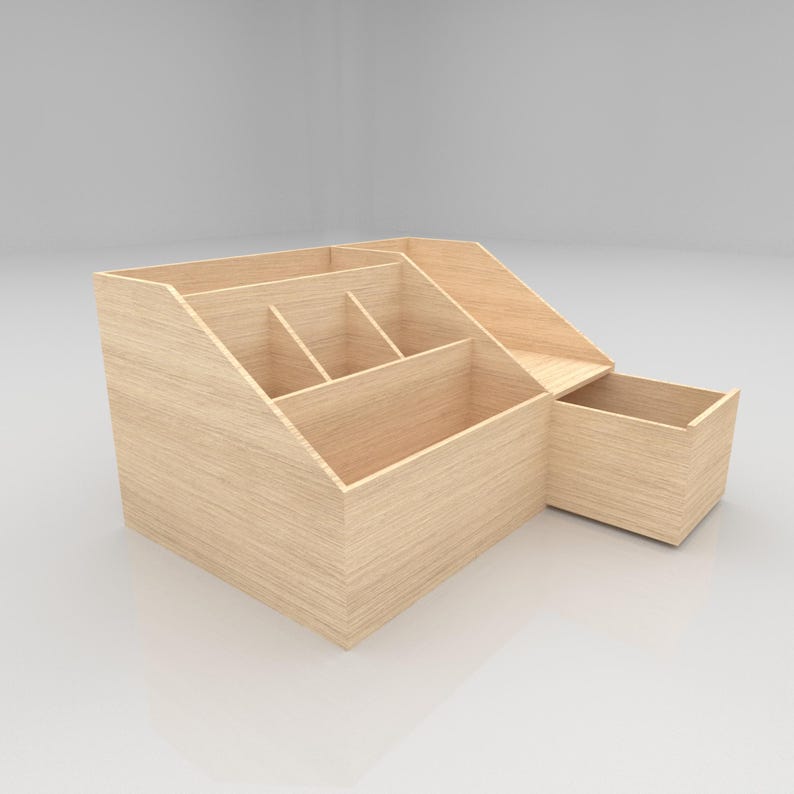May include: A light-colored wooden desk organizer with multiple compartments and a small drawer. The organizer has a sloped design with various sections for storing office supplies. The wood grain is visible, giving it a natural look.