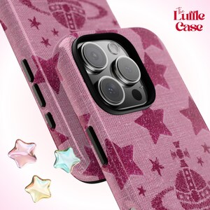 May include: A pink phone case with a glittery star pattern and a black camera lens. The case has the text "The Luffle Case" printed on it.