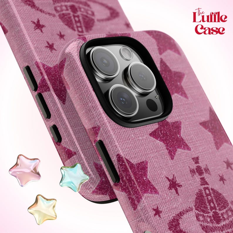 May include: A pink phone case with a glittery star pattern and a black camera lens. The case has the text "The Luffle Case" printed on it.
