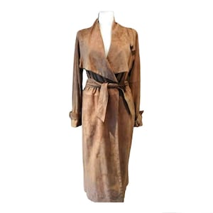 May include: A long brown suede trench coat with a wrap-style collar and a self-tie belt.