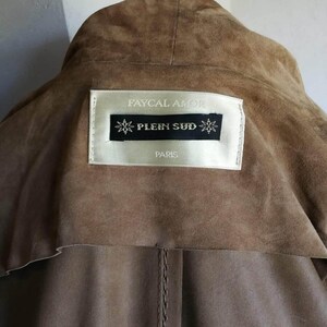 May include: Brown suede jacket with a label that reads "Faycal Amor" and "Plein Sud" Paris.