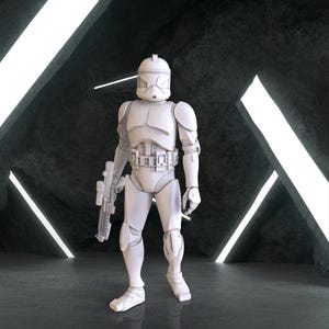 Peut inclure: Une figurine d'action en plastique blanc d'un clone trooper de Star Wars, debout avec un fusil blaster dans sa main gauche. La figurine est posée debout, la main droite levée. La figurine est debout sur une surface grise avec des lumières blanches en arrière-plan.