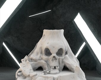 May include: A white, skull-shaped sculpture with a mountain-like structure. The sculpture features a detailed skull face, a staircase, and a cave-like opening. The background is a dark, textured wall with bright, white linear lights.