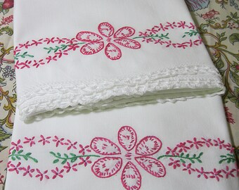 Vintage hand embroidered pillowcase pair, pink and green large flower petals and daisy chain with white crocheted edge, 20.5 x 29 inches