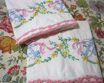 Hand embroidered vintage pillowcase pair, blue wedding bells, pink, yellow and green, with pink crocheted edge, 20 x 30 inches