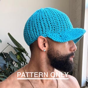May include: A turquoise crochet baseball cap with a curved brim. The cap is made of a textured, open-weave fabric. The text "PATTERN ONLY" is displayed in white across the bottom of the image.