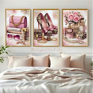 May include: Three framed art prints featuring fashion accessories. The first print shows a pink quilted handbag, sunglasses, and books. The second print displays leopard print high heels and a lipstick. The third print showcases pink roses, perfume, and jewelry.