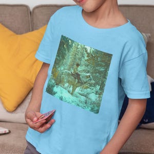 Winter Wolf Rider Kids T-Shirt, Snowy Forest Adventure Tee, Child & Wolf Fantasy Shirt, Arctic Wolf Clothing, Magical Nature Outfit for Kids