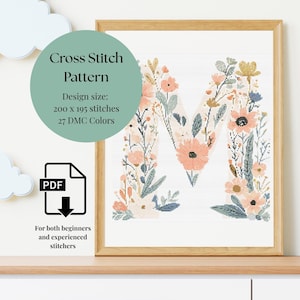 May include: A framed cross-stitch pattern featuring the letter "M" adorned with floral designs in peach, yellow, and blue hues. The design size is 200 x 195 stitches, using 27 DMC colors. The pattern is suitable for both beginners and experienced stitchers.