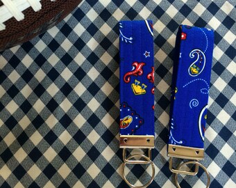 May include: Two blue and white patterned keychains with silver key rings. The keychains have a paisley design with red and yellow accents.