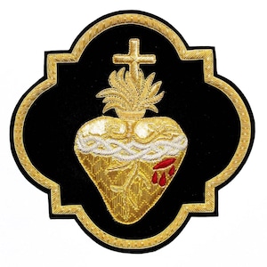 May include: Embroidered patch featuring a golden heart with a crown of thorns, flames, and a cross, set against a black background. The heart has red droplets. The patch is framed with a gold border.