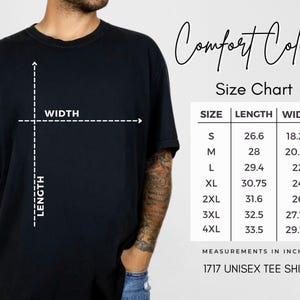 May include: Black t-shirt with a size chart and the words "Comfort Colors." The size chart shows measurements in inches for sizes S to 4XL. The shirt is labeled as a 1717 unisex tee shirt.