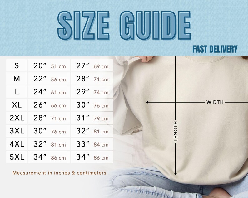 May include: A size guide chart with measurements in inches and centimeters for a sweatshirt. The chart includes sizes S to 5XL, with corresponding width and length measurements. The text "SIZE GUIDE" is at the top.