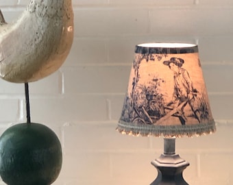 Lamp and shade, blue lamp base with shade in a toile fabric, trim lamp