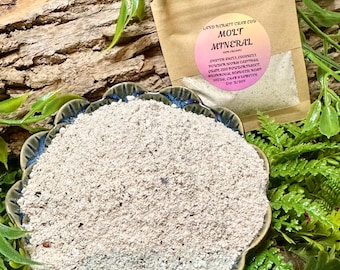 May include: A beige, granular powder mixture in a scalloped-edge bowl and a brown paper pouch labeled Land Hermit Crab Edu Molt Mineral, containing oyster shell, eggshell powder, worm castings, quail egg powder, mushroom, seaweed, hemp seeds, and clay.