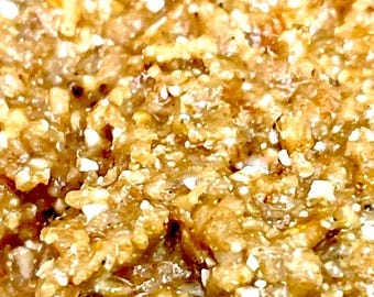 May include: Close-up of a brown and white textured food with a grainy texture.