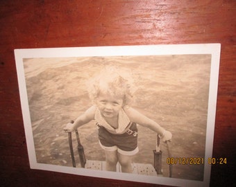 Vintage Water Baby Snapshot Old Black And White Snapshot Photograph Of A Possibly Reluctant Curly Haired Babe On A Ladder Waterside