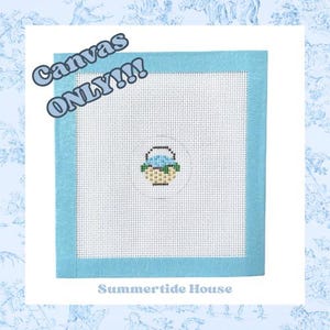 May include: A needlepoint canvas with a light blue border and a central design of a basket filled with blue flowers. The text "Canvas ONLY!!!" is in the upper left corner, and "Summertide House" is at the bottom.