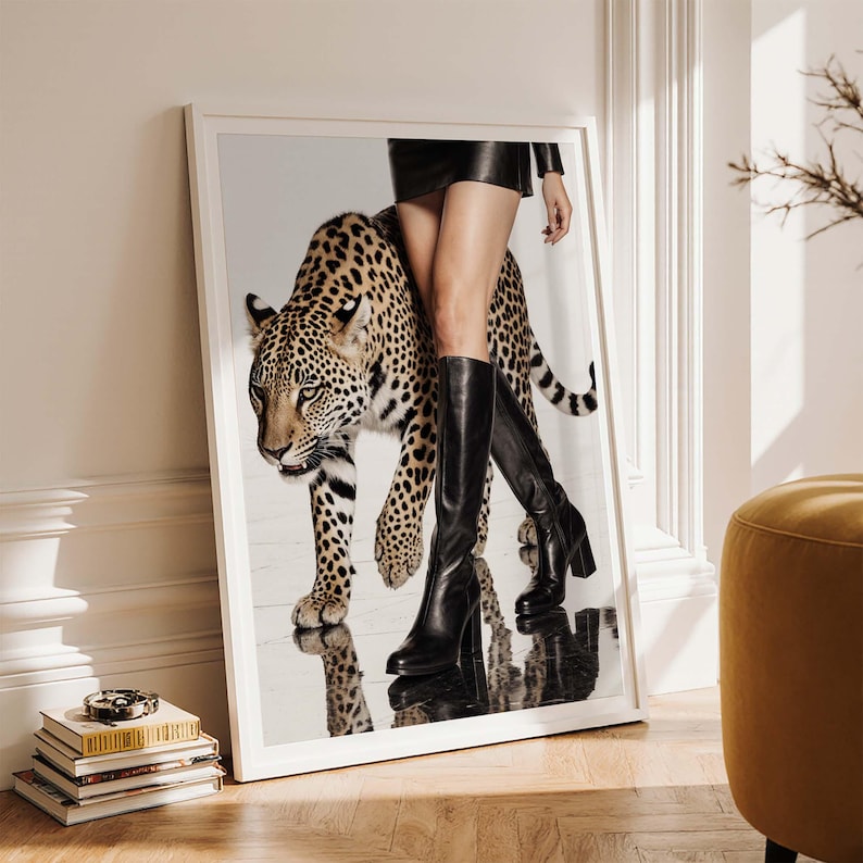 May include: A framed art print featuring a leopard with a woman wearing a black leather skirt and knee-high black boots. The leopard has a spotted coat. The image is set against a reflective surface, creating a mirrored effect.