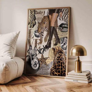May include: A framed collage with a gold-coloured frame, incorporating leopard print, newspaper cuttings, and fashion imagery. The artwork includes a leopard, lips, and legs in black boots. The word "Daily" is visible, along with "XOXO" and "LOVE".
