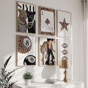 May include: A set of framed art prints with leopard print and fashion themes. Prints include a leopard and black panther, playing cards, a star, an 8-ball, a leopard with boots, and leopard print lips.