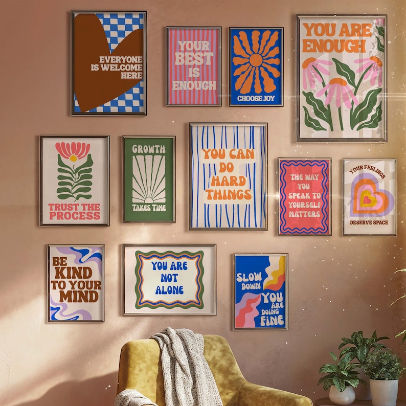 May include: A collection of framed art prints with motivational quotes and floral designs. The prints feature phrases like "You are enough," "Choose Joy," and "Trust the process." The color palette includes shades of blue, pink, green, and orange.
