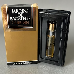 May include: A small bottle of Guerlain Jardins de Bagatelle Eau de Toilette, 2 ml / .07 fl oz, in a gold and black box. The perfume bottle is inside a black plastic holder. The box has the perfume name and brand.