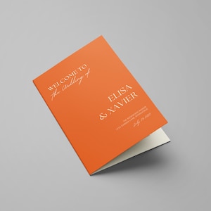 May include: Orange wedding program with the text "Welcome to the wedding of Elisa & Xavier" and the date "July 16, 2023".