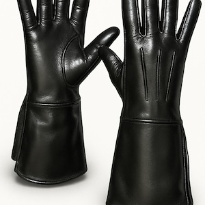 May include: A pair of black leather gloves with long gauntlets. The gloves have a smooth texture and are designed with a classic, elegant style. The fingers are well-defined, and the gauntlets extend up the forearm.