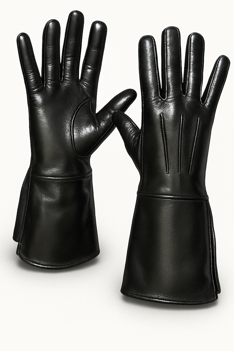 May include: A pair of black leather gloves with long cuffs. The gloves have a simple design with stitching on the back of the hand.