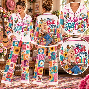 May include: A white pajama set with a colorful patchwork pattern of sunflowers, daisies, and butterflies. The top features the text A Life in Full Color and The Coat of Many Colors with an illustration of a woman playing a guitar.