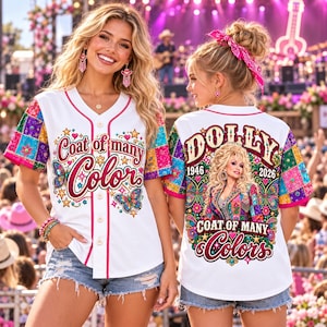 May include: A white button-down baseball jersey featuring a colorful patchwork pattern on the sleeves. The front displays the text Coat of many Color with butterfly graphics. The back features a portrait of Dolly with the text DOLLY 1946 2026.