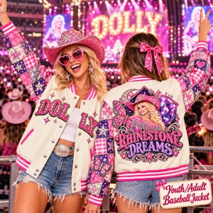 May include: A cream-colored baseball jacket with pink and purple patchwork sleeves featuring stars, butterflies, and gingham patterns. The back displays a graphic of a woman in a cowboy hat, a disco ball, and the text Rhinestone Dreams.